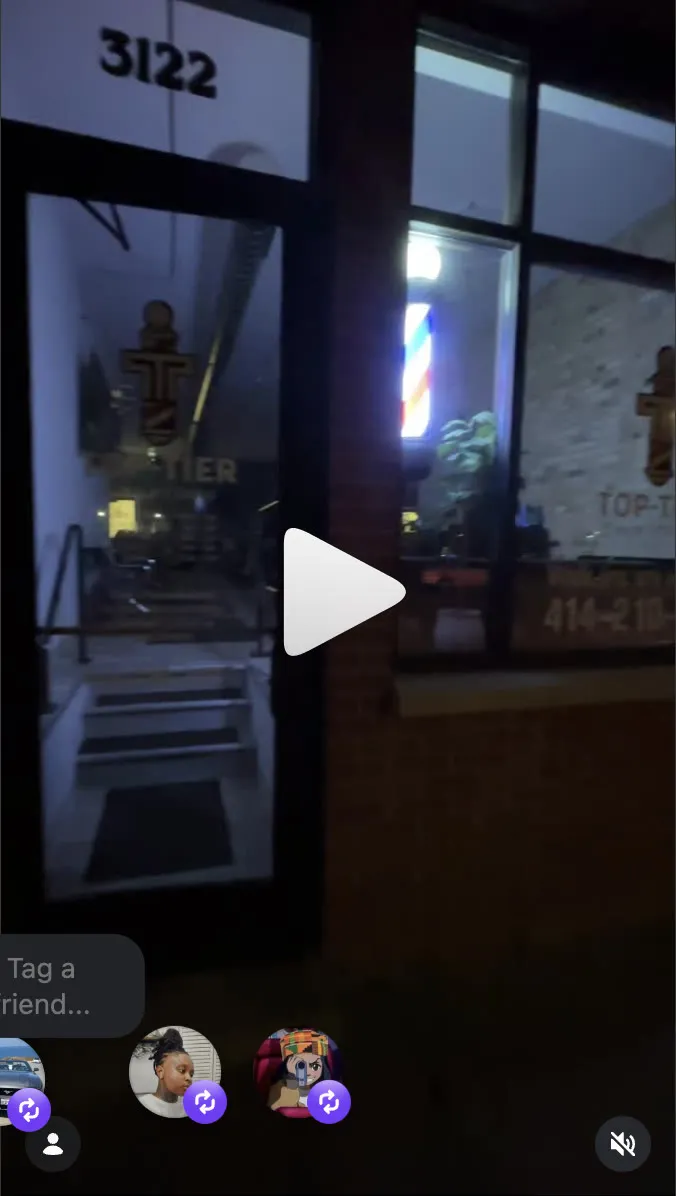 Top Tier Hair Studio storefront at night