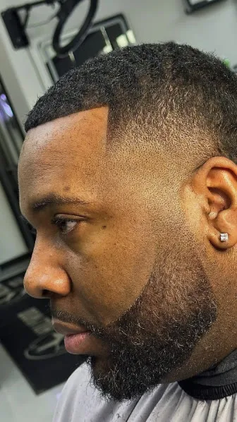 Sharp fade with lined beard, client at Top Tier Hair Studio
